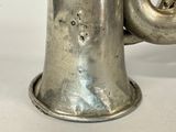 a silver cup with a handle on a table