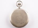 an old silver pocket watch with a chain on a white surface
