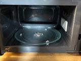 a microwave that has a glass bowl inside of it