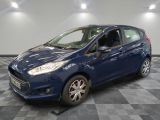 a blue ford fiesta parked on a checkered floor in a garage