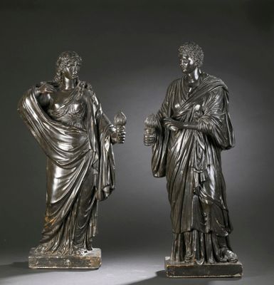pair of bronze statues of a man and a woman