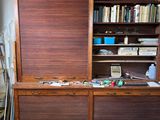 a large wooden bookcase with many books on top of it