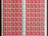 une feuille de timbres rouges et blancs sur un fond noir