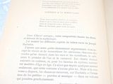 un livre ouvert posé sur une table recouverte d'une nappe bleue