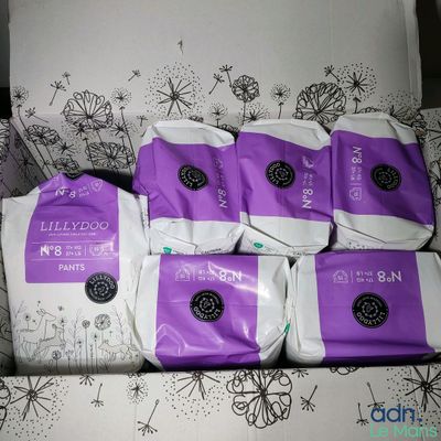 five bags of diapers sitting on top of a couch