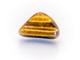 a close up of a tiger ' s eye stone on a white surface