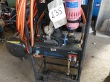 a cart that has a bunch of hoses on top of it
