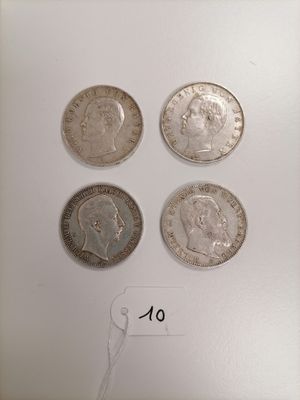 four different types of coins are shown on a white surface
