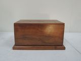 a small wooden box with a lid on a white surface