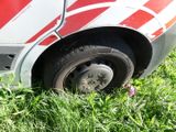 a red and white van that is parked in the grass