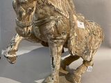 a statue of a horse that is standing on a table