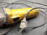 a yellow and black electric tool sitting on a table