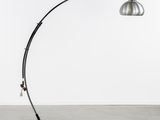 a black and silver floor lamp with a metal shade