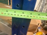 a measuring tape on a piece of metal in a room