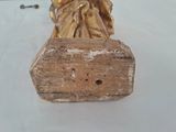 a gold statue of a woman on a rock