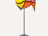 a close up of a colorful fish sculpture on a black stand
