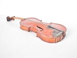 an old violin sitting on top of a white surface next to a white wall