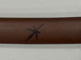 a close up of a brown leather case with birds on it