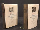 two books on a table with a black background and a black background