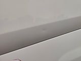 a close up of a door handle on a white car