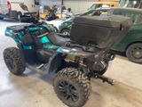an image of a blue and black atv parked in a garage
