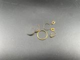 a close up of a pair of gold rings on a black surface
