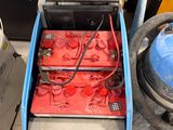 a machine that is sitting on the floor next to a trash can
