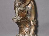bronze statue of a man and a child on a tree stump