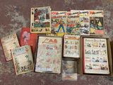 a lot of old comic books on the floor