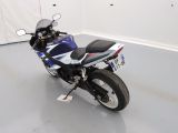 a blue and white motorcycle parked in a room