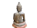 statue of a seated buddha on a pedestal with a white background