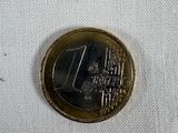 a one euro coin sitting on a white cloth