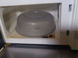 a microwave with a lid on it sitting on a counter
