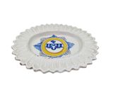a white plate with a blue and yellow emblem on it