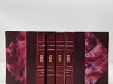 the three books are lined up in a row on a white surface