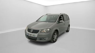 a grey van is parked in a white room with white walls