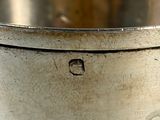 a metal container with a hole in it