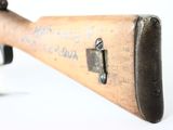 an old wooden rifle with a black handle and a white background