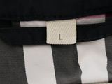 a black and white striped bag with a white tag on it