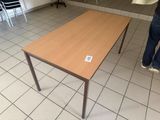 a person standing in front of a table with a sticker on it
