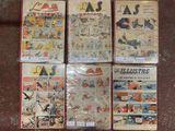 several comics are on display on a table in a room