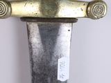 a close up of a knife with a tag on it