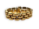 a close up of a gold bracelet on a white background