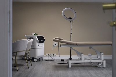 a room with a table, chair, and a light in it