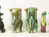 four different vases sitting next to each other on a table
