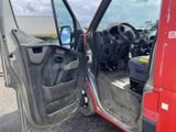 a red truck with the door open and the driver ' s seat down