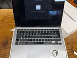 a laptop computer sitting on top of a wooden table