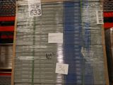 a large stack of boxes with a price tag on them