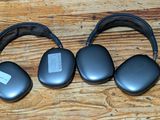 three headphones that are sitting on a wooden table