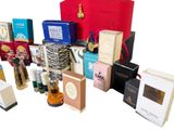 many different types of perfumes and boxes on the table